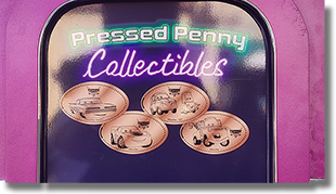 Link to guide listing for CA0310-313 Cars Land Ramone's House of Body Art  on Route 66 Ramone, Lightning McQueen, Luigi & Guido, Mater. Hand Crank four-play penny press, resembles an old-style gas pump painted a pinkish purple.CA0310-313 Marquee 4-26-2024.