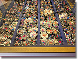 Window: Main Street Penny Arcade / Candy Palace - Main Street, Disneyland Park, USA. Button 1: #247 Colorized metallic silver medallion, 70th Logo, Santa Mickey Mouse with stars in the design field, red ring at the medallion rim. Button 2: #248 Colorized metallic silver medallion, 70th Logo, Santa Minnie Mouse with stars in the design field and a red ring at the medallion rim. Button 3: #249 Colorized metallic silver medallion, 70th Logo, Santa Winnie The Pooh with stars in the design field, a copyright notice across the bottom of the image and a red ring at the medallion rim. Button 4: #250 Colorized metallic silver medallion, 70th Logo, Stitch with stars in the design field and a red ring at the medallion rim. Onstage November 4, 2025.