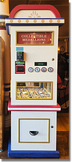 Machine Image: Candy Palace - Main Street Penny Arcade Colorized Medallions.  Button 1: #303 Happy 250th Mickey Mouse.  June 14, 2026.  Button 2: #304 Happy 250th Minnie Mouse, June 14, 2026.  Button 3: #254 70th Logo, Classic Disneyland Seven Flag Roadside Marquee with stars in the design field. December 25, 2025. Button 4: #252 70th Logo, Walt and Mickey, Partners with stars in the design field. December 25, 2025.