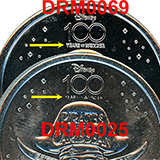 View large image comparison of the #25 and #69 Skull and Cross Bones Disney 100 medallions.