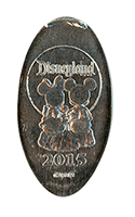 DL0596 Retired 2015 Mickey & Minnie Sitting with arms around each other elongated coin image. 